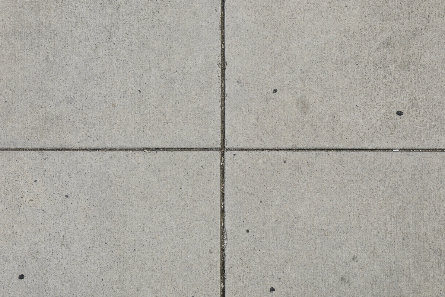 A poured concrete surface with expansion joints running through it, photographed by us from directly above.