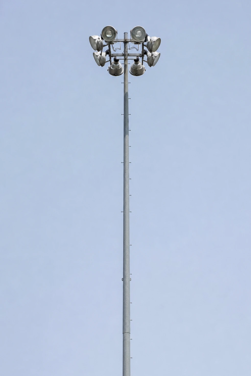 A municipal light mast we photographed frontally against flat sky in a tall frame, carrying no lettering.